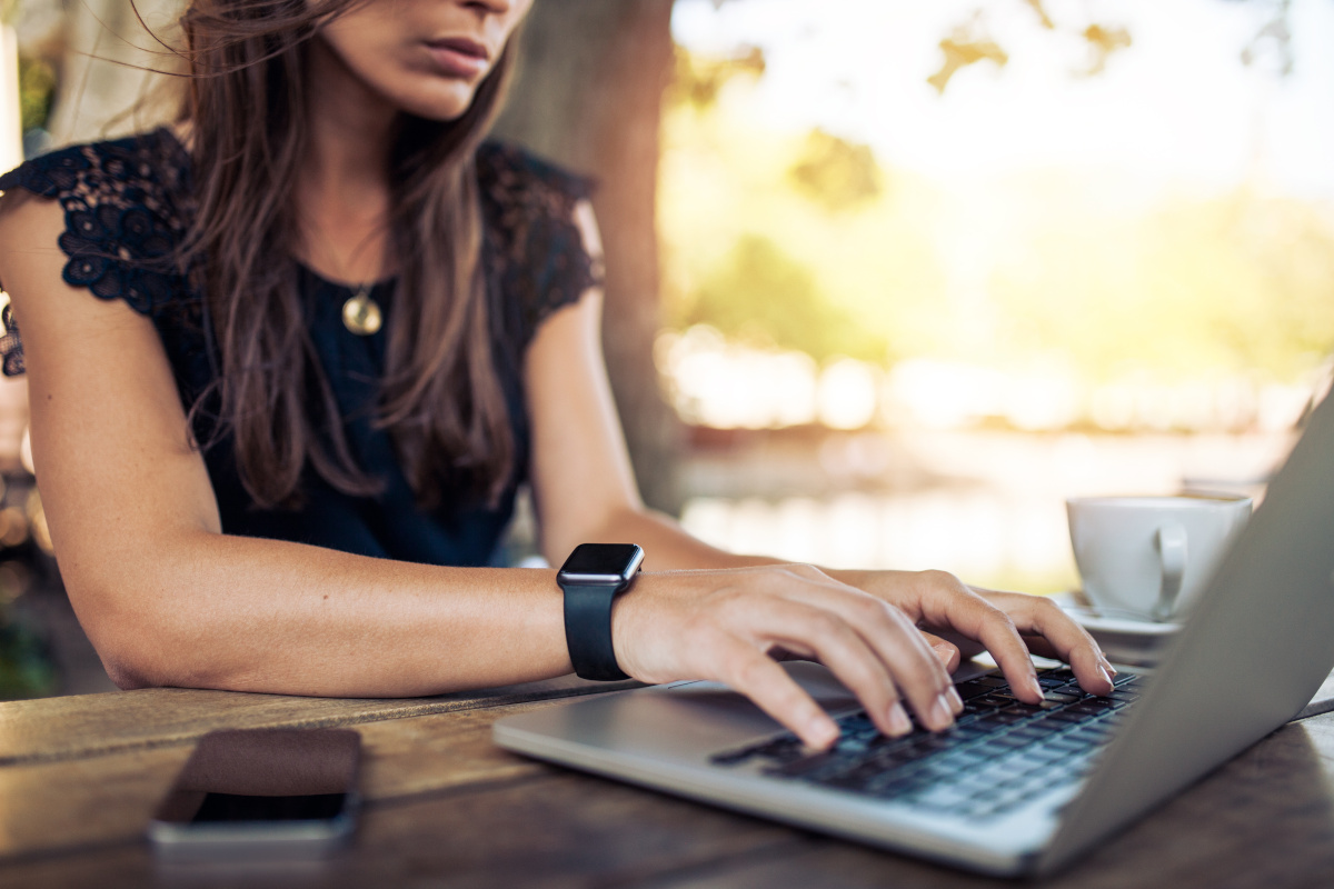A woman typing on her laptop